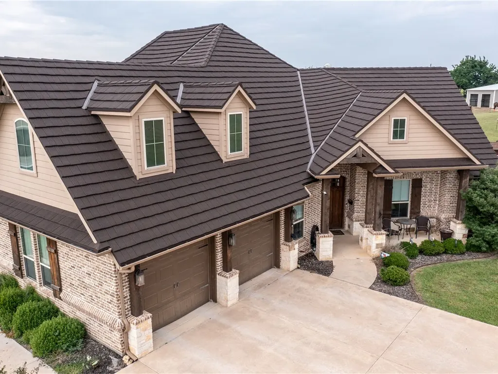A home with a dark brown steel roof that looks like wood shake.