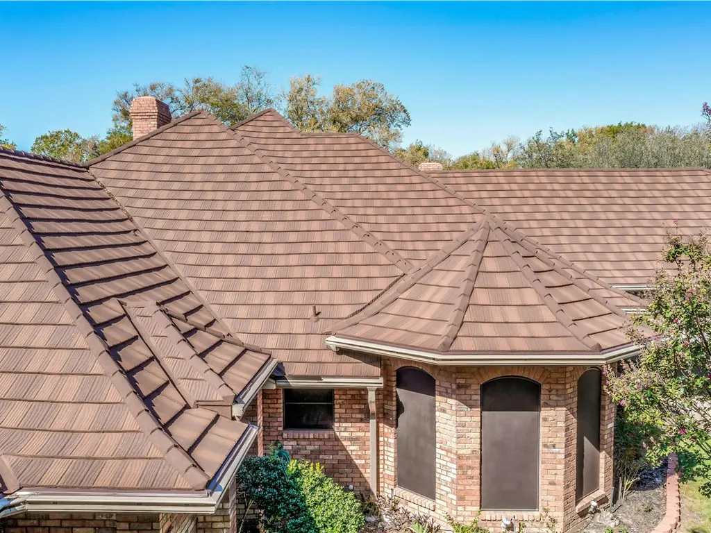 A close view of a saddle brown steel roof that looks like wood shake.